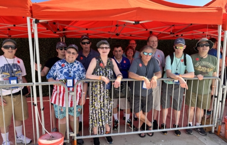 travelers and staff waiting for the Gator show under an orange tent