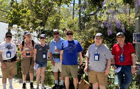 Travelers in the Butterfly Aviary with butterflies flying all around