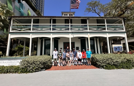 Travelers standing in front of the Stranahan house
